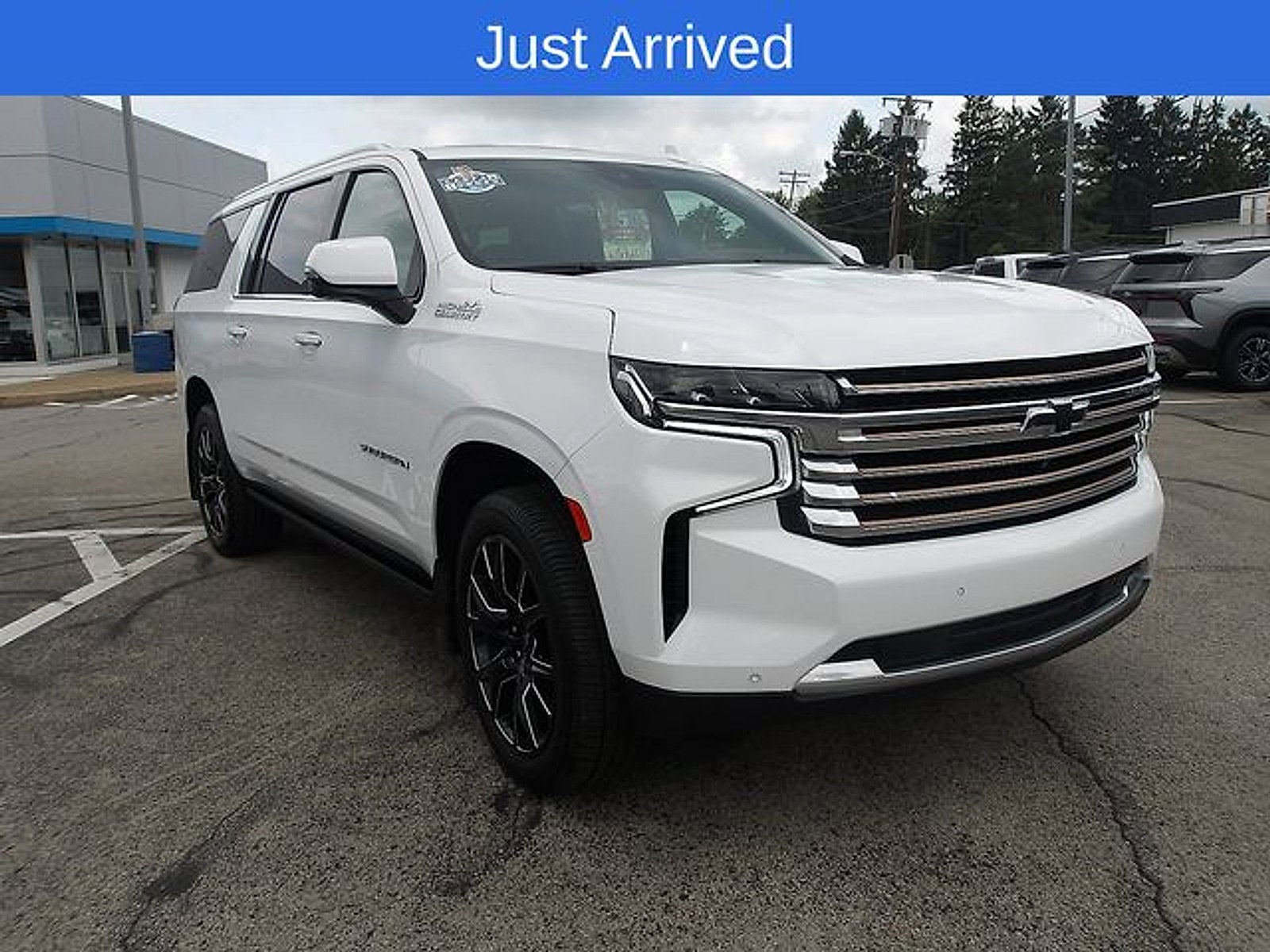2023 Chevrolet Suburban High Country in Summit White — front three-quarter view