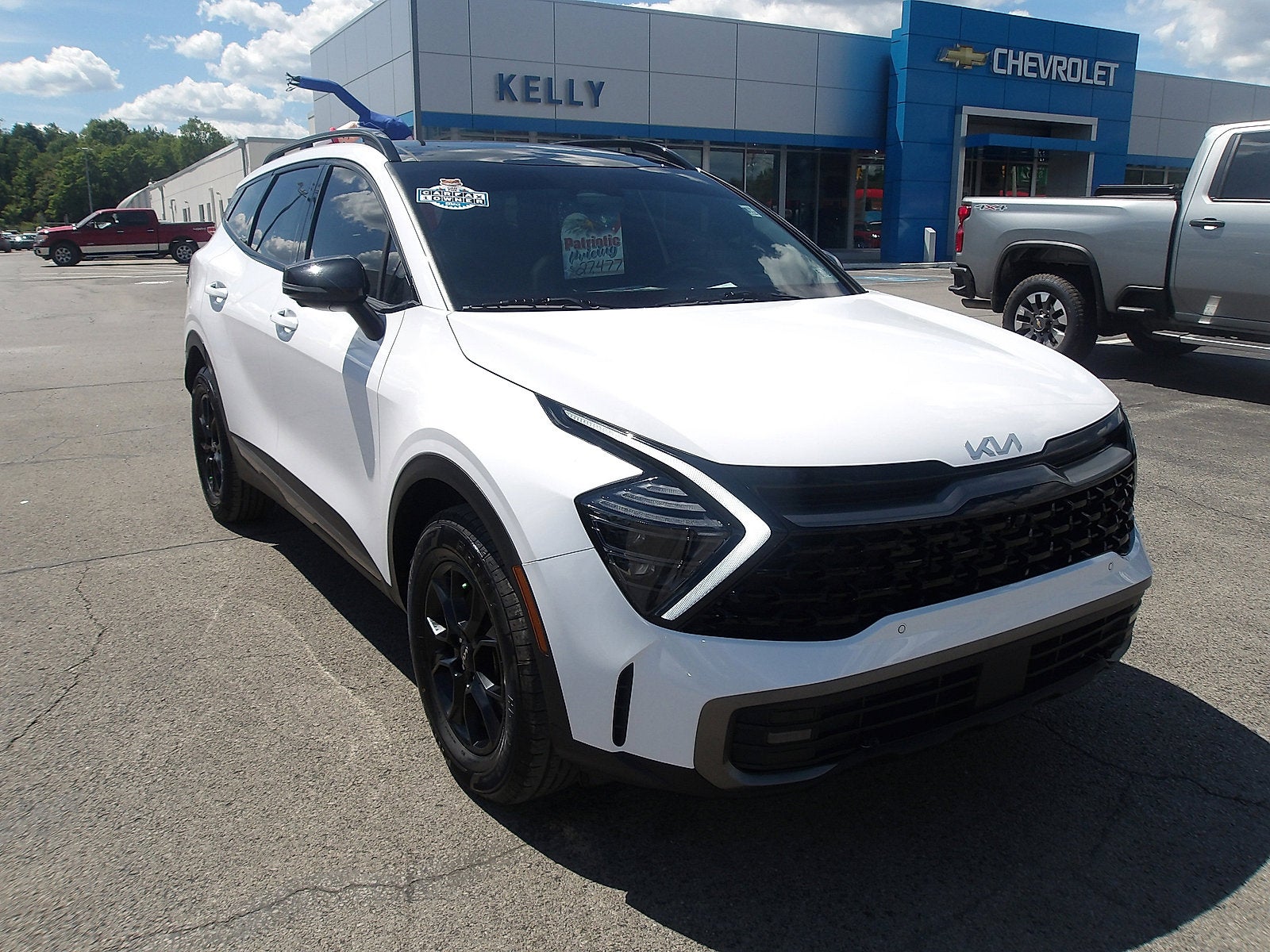 2023 Kia Sportage X-Pro Prestige in Glacial White Pearl — front three-quarter view