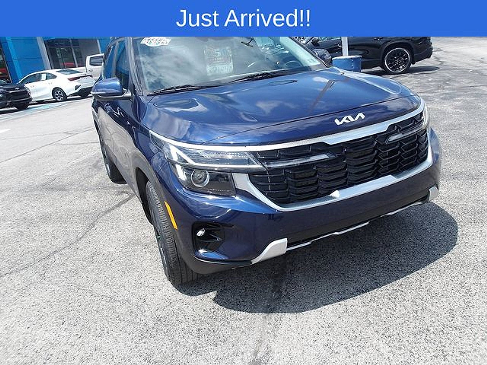 2024 Kia Seltos EX in Dark Ocean Blue — front three-quarter view